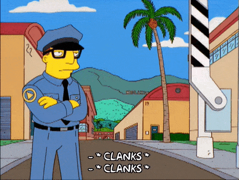 A Simpson police character wearing glasses has a bored expression while standing in front of a checkpoint area.