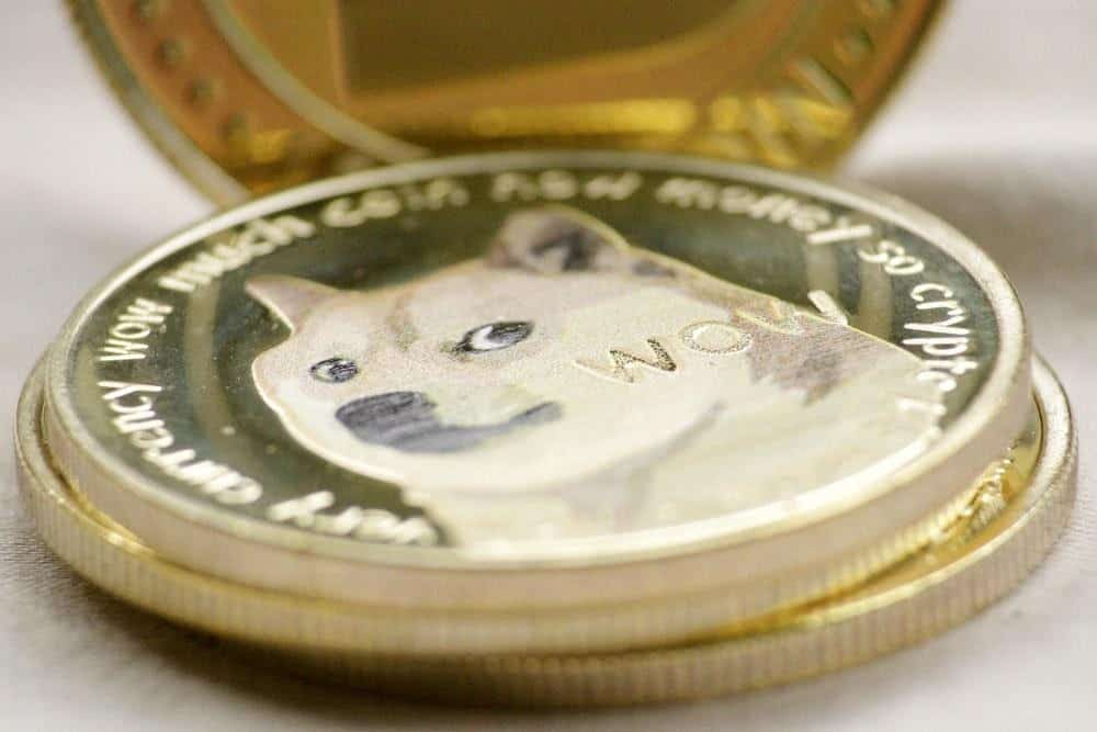 Two Dogecoin laid on top of a wooden table.  Shiba Inu, an internet dog sensation usually featured on memes, can be seen in the middle with a WOW label on the lower right side. 